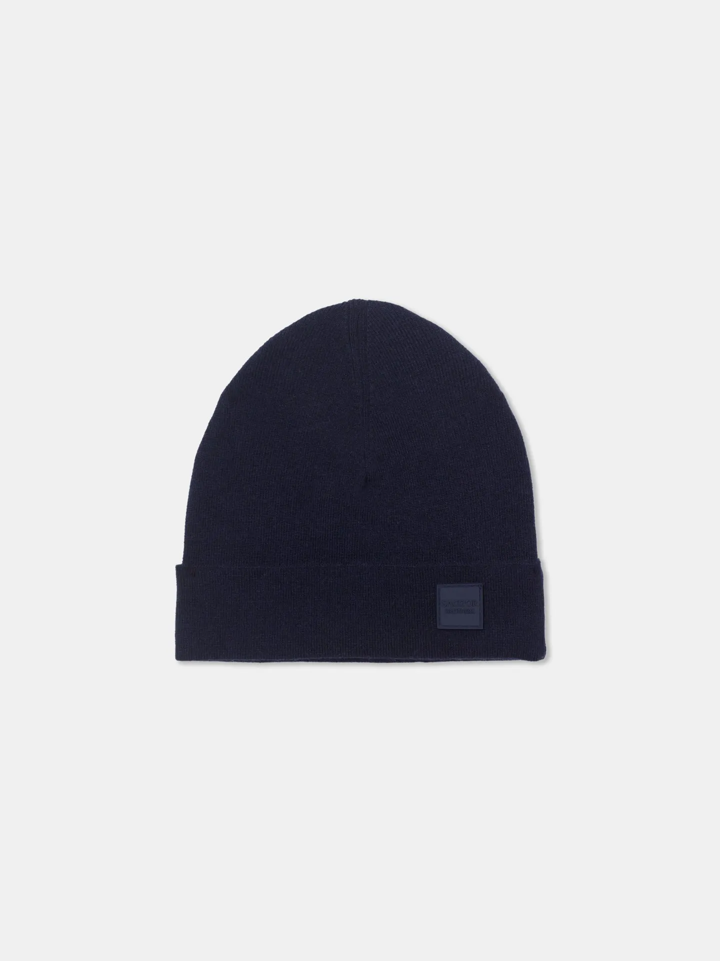 Knitted beanie with silicone badge